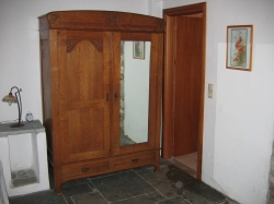 a cupboard from the early 19th century with a mirrored door.